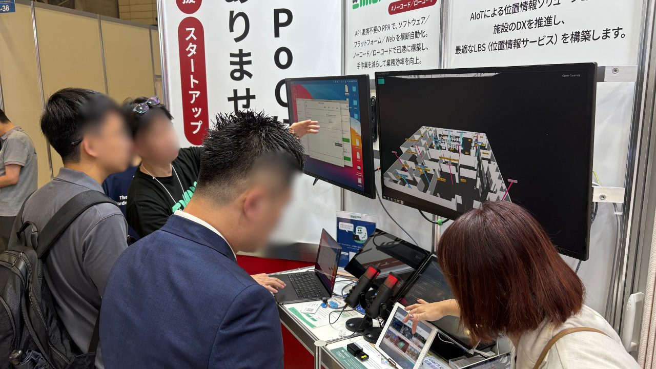 Visitors engaging with product demos at a client booth, NEPCON Japan