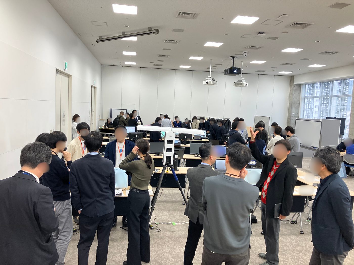 Visitors gathered around live product demos at an in-house exhibition in Tokyo