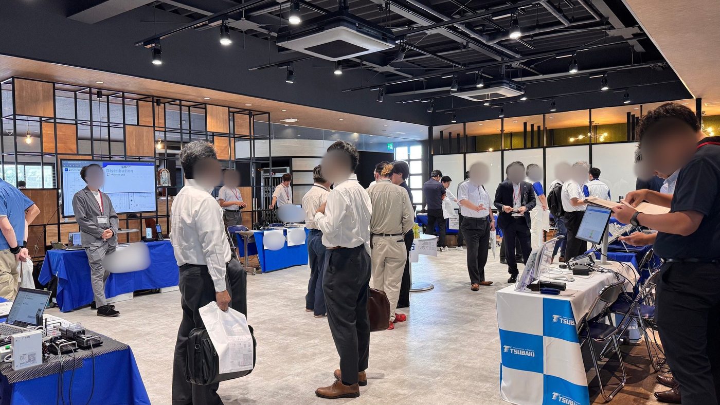 Guests touring demo tables at an invitation-only seminar and exhibition in Tokyo